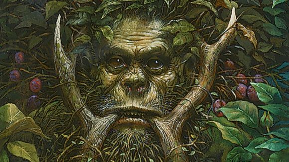 magic the gathering commander mark rosewater, a tusked, ape like creature peering through branches.