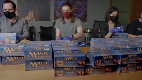 Magic The Gathering Dominaria United Legends 1994 - a group of people wearing face masks unboxing MTG Legends product.