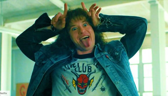 DnD Stranger Things Eddie Munson - Eddie Munson sticks his tongue out and forms mock devil horns above his head with his hands